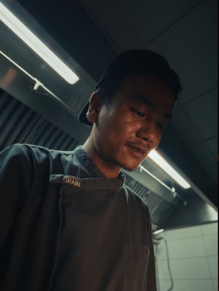 A chef at work in a low-lit kitchen — a graded frame from Quick Films footage